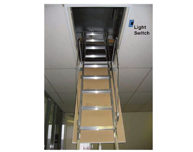 Attic access ladder lowering from a ceiling hatch into a room, with a blue light switch on the wall labeled 'Light Switch' nearby, metal steps visible.
