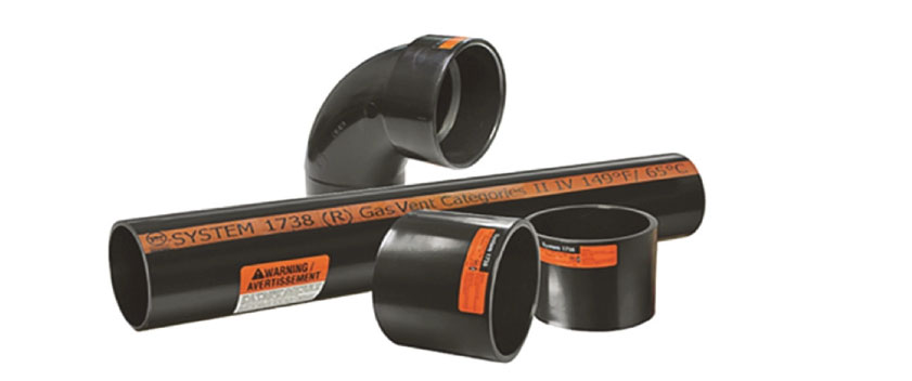 Assorted black PVC plumbing pipes and elbow fittings with orange labels stacked together